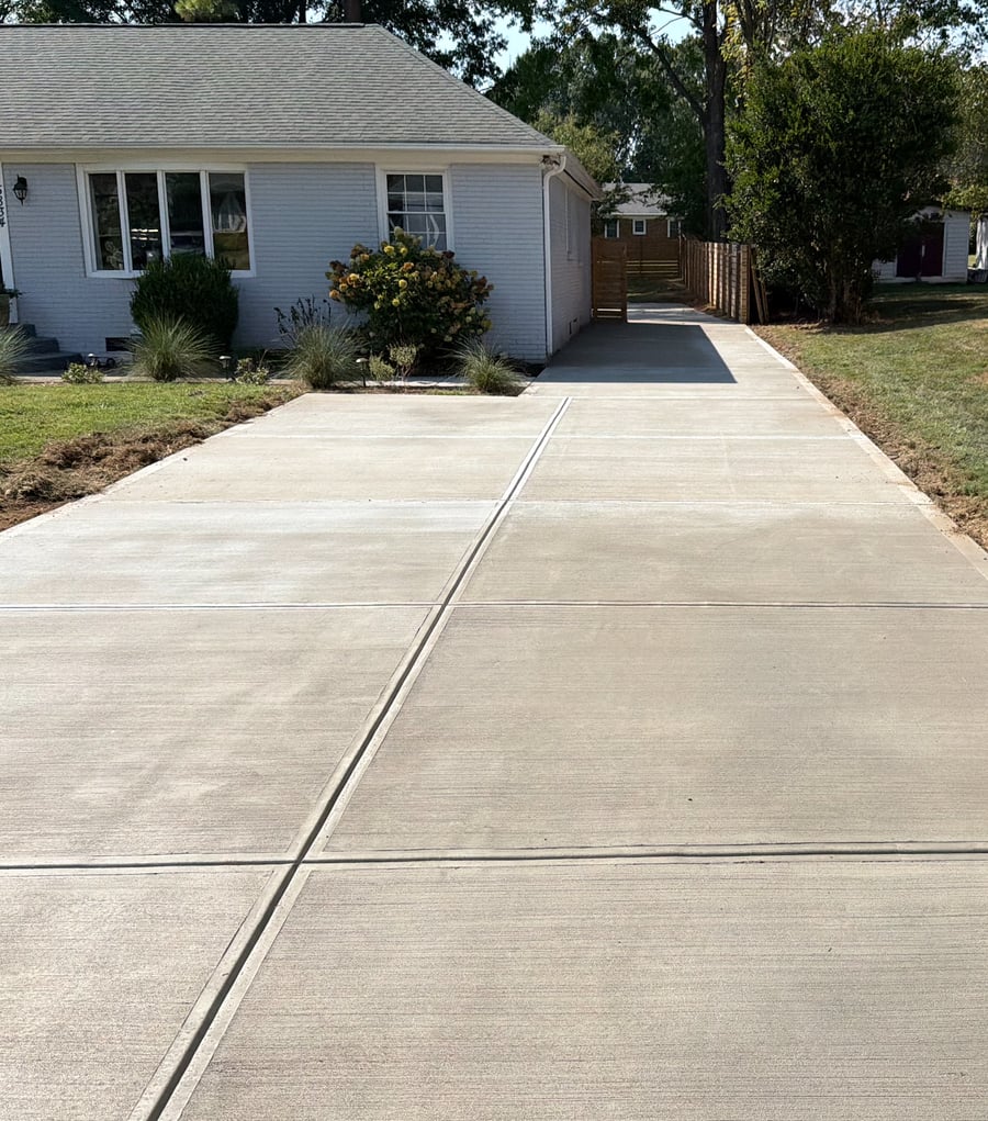 The finished concrete driveway, running from the street up to the house