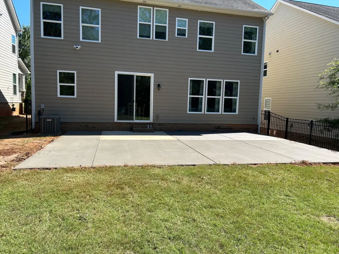 Concrete patio extension across the backyard