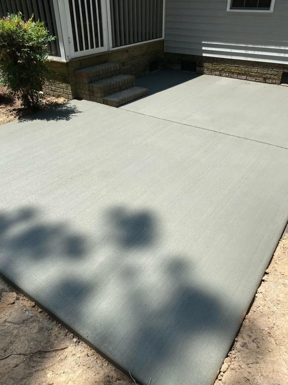 Concrete patio and steps at the back of a home